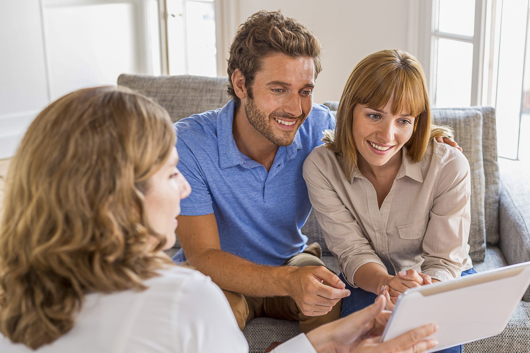Real-estate agent presenting a new project property on digital t